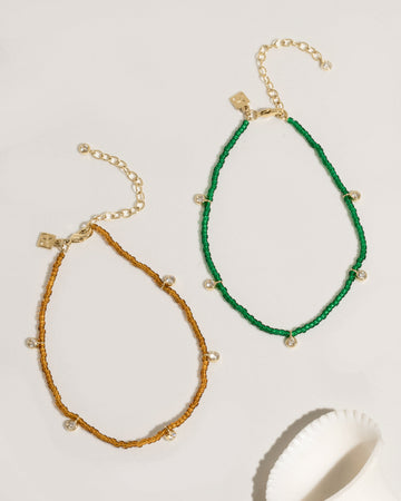 Beaded anklet with mixed crystal and gold bead accents on elastic cord